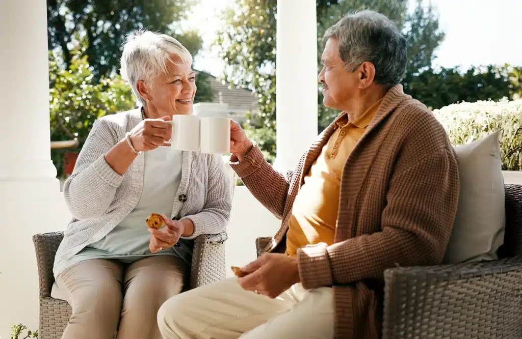 A couple ladies enjoying their time talking outdoors with sitting in chairs