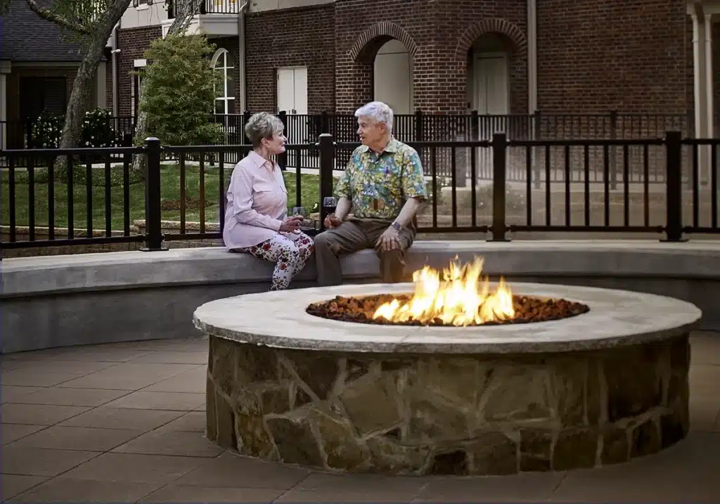 A couple sits by the firepit