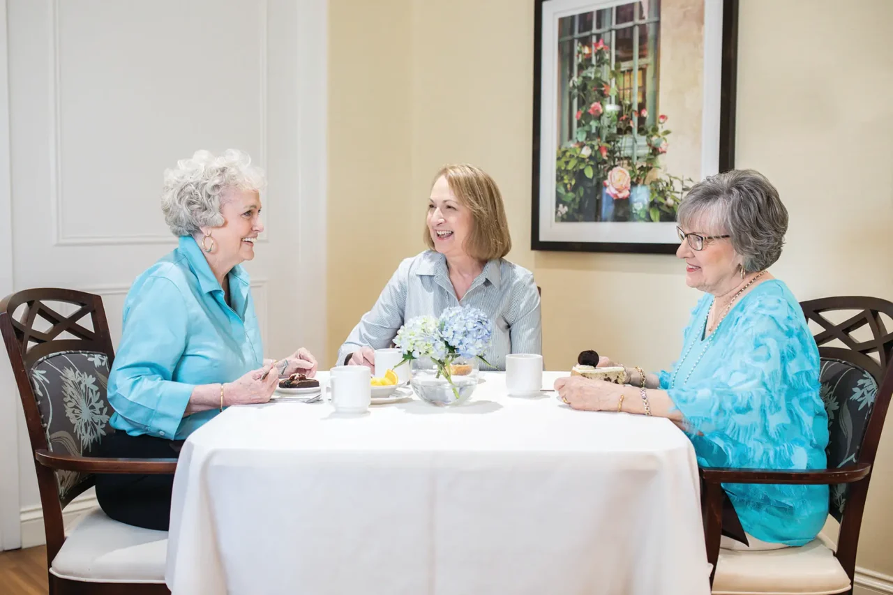 Three women enjoying coffee together at a table
