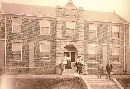 Historial image of the glen with a group of people standing in the entryway