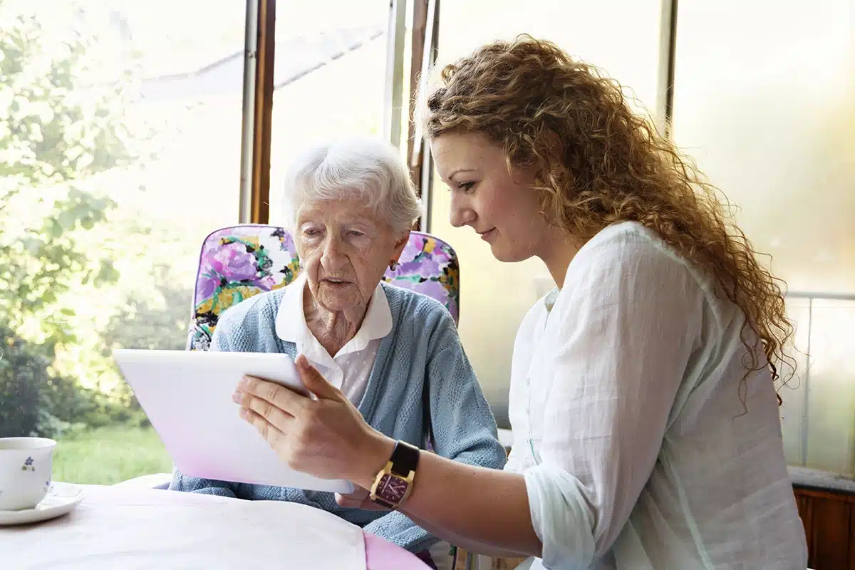 a caregiver going over paperwork with an older women in Shreveport, LA