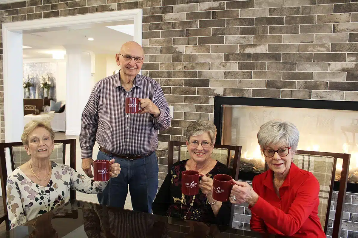 A group of people raising mugs