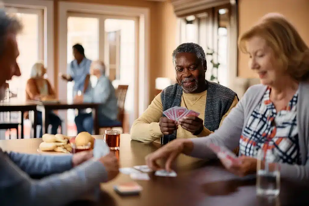 a group of residents playing cards at a table